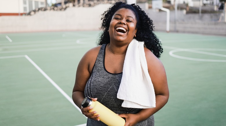 woman smiling on basketball court