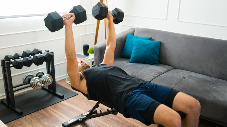 man doing dumbbell bench press