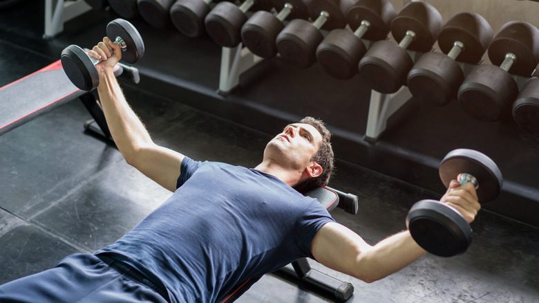 man doing dumbbell chest flys