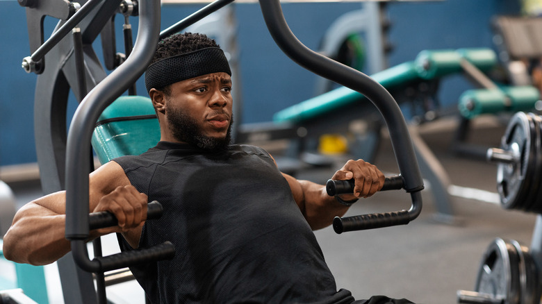 man doing machine bench press