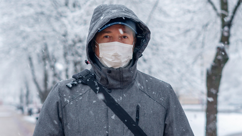 Man wearing mask in snow storm