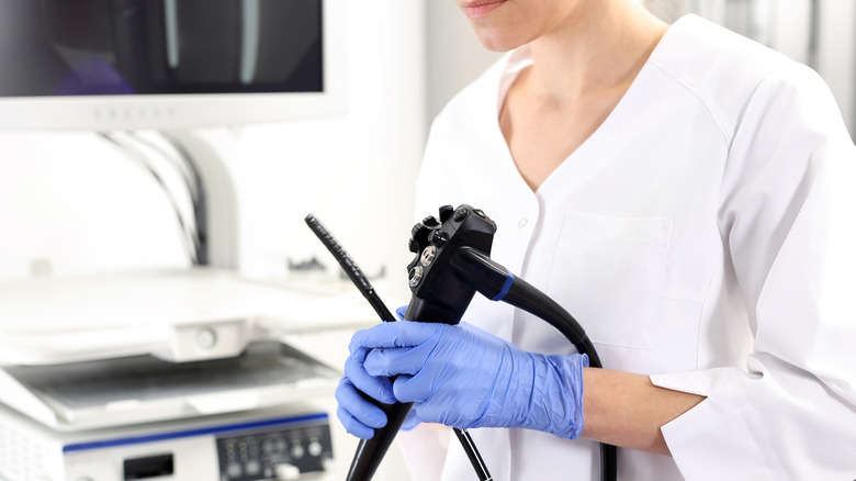 Doctor holding colonoscopy equipment