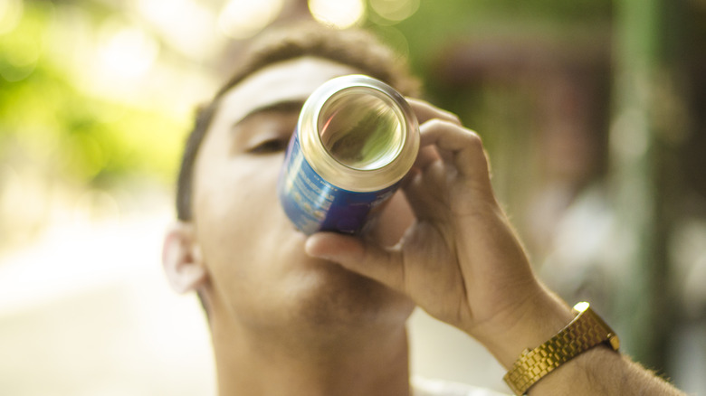 boy drinking out of can