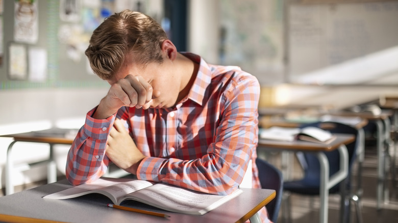 Tired student falling asleep in class