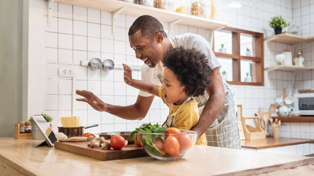 father and child cooking in the kitchen