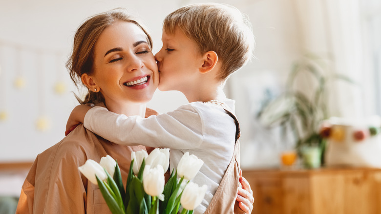 son kissing mom's cheek