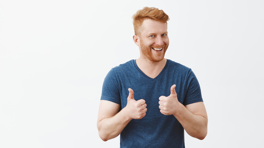 Redhead man with thumbs up