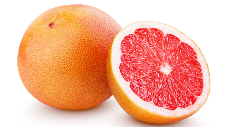 One full grapefruit alongside a half a grapefruit