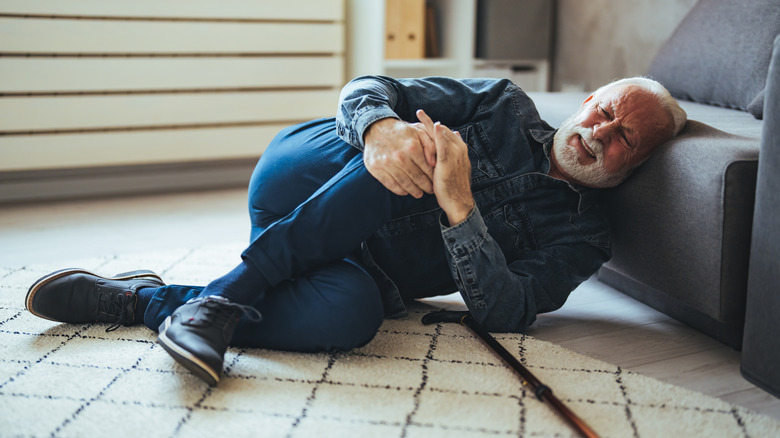 older man lying on the floor after falling