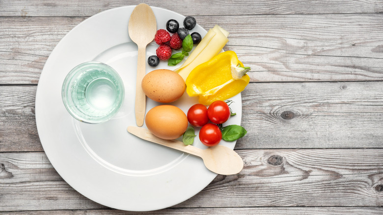 plate of fruit, vegetables, and eggs shaped like a clock