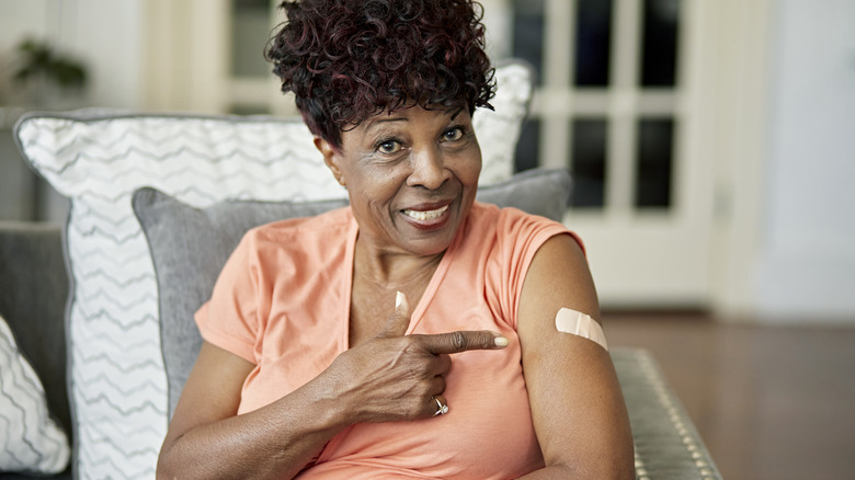 senior woman proudly getting vaccine