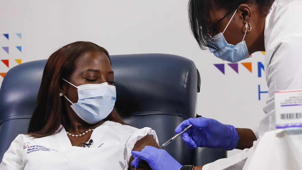 A nurse receives the Pfizer coronavirus vaccine at Long Island Jewish Medical Center in Queens, New York, in January