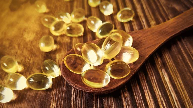 Omega-3 supplements in a wooden tablespoon 