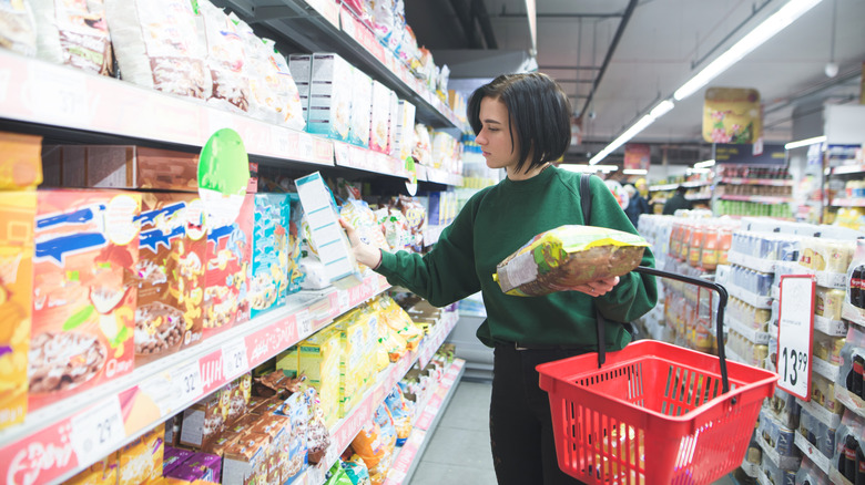 woman picking up snacks
