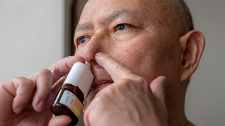 man using nasal spray