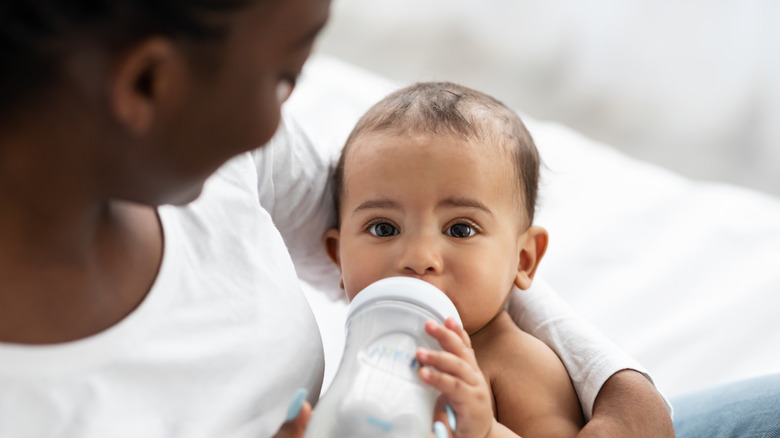 Mother bottle feeding her baby