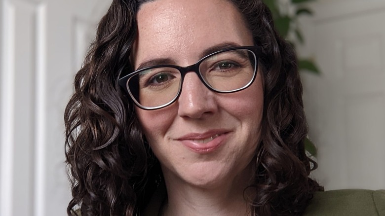 Headshot of Carla Cevasco wearing dark rimmed glasses