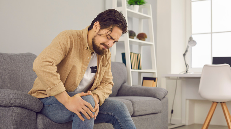 Man holding his leg in pain