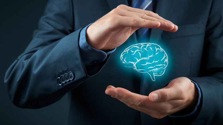 Person in suit and tie "holding" brain