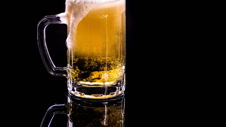 An overflowing mug of beer
