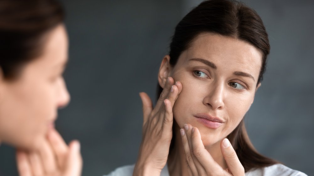 woman looking in mirror