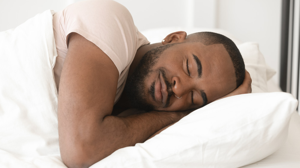 Man sleeping peacefully in a bed