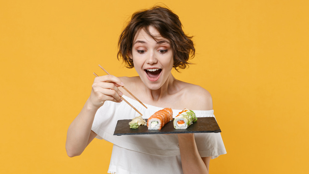 woman using chopsticks, sushi