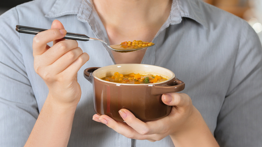 woman eating lentil soup