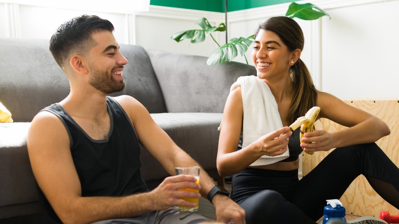 couple enjoying snacks before workout