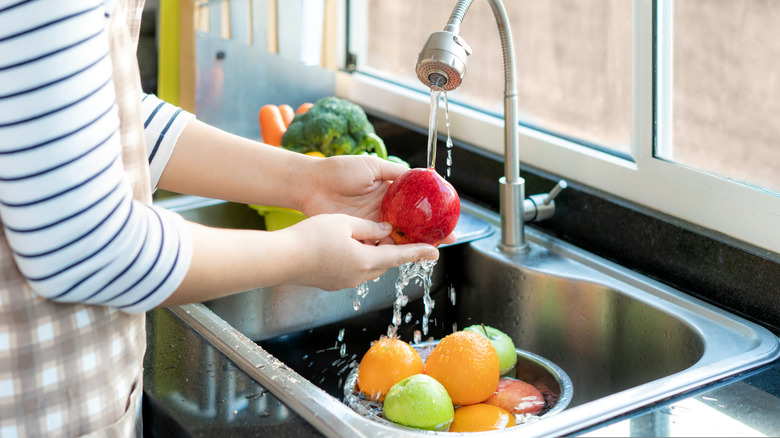 woman washing fruit 