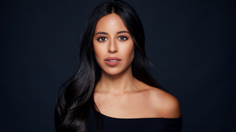 Headshot of Naz Perez against a black background
