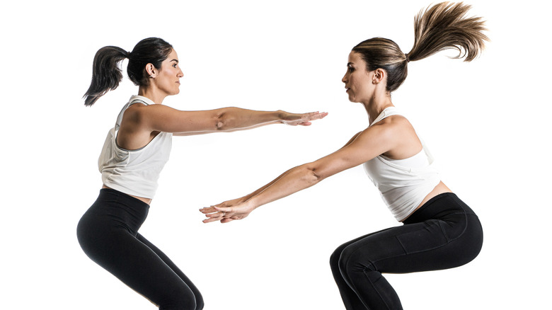 Women doing frog jumps