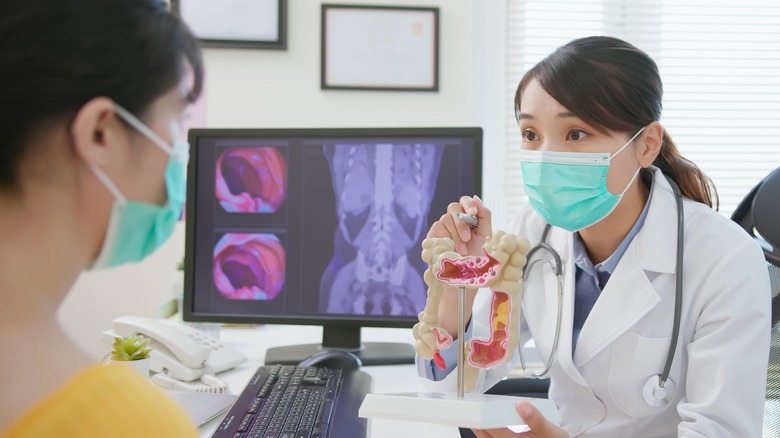 Doctor showing patient anatomic model