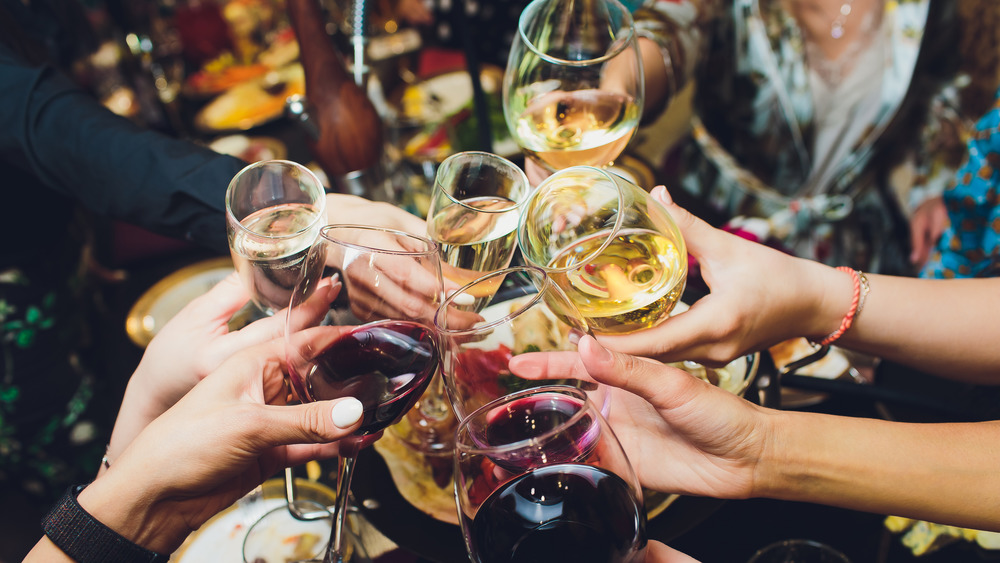 Closeup of various people toasting with wine