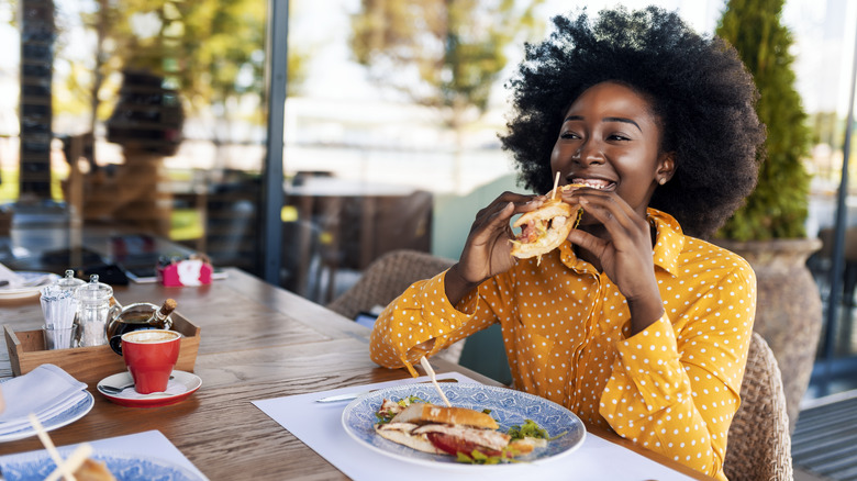woman eating healthy sandwich for lunch