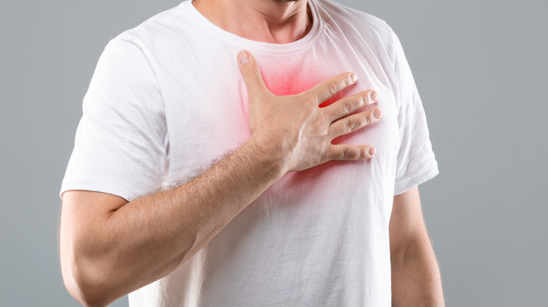 Man clutching his inflamed chest 