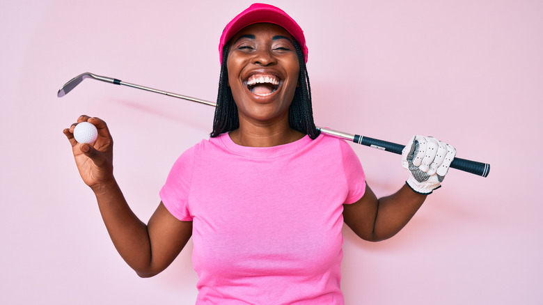 Female golfer smiling