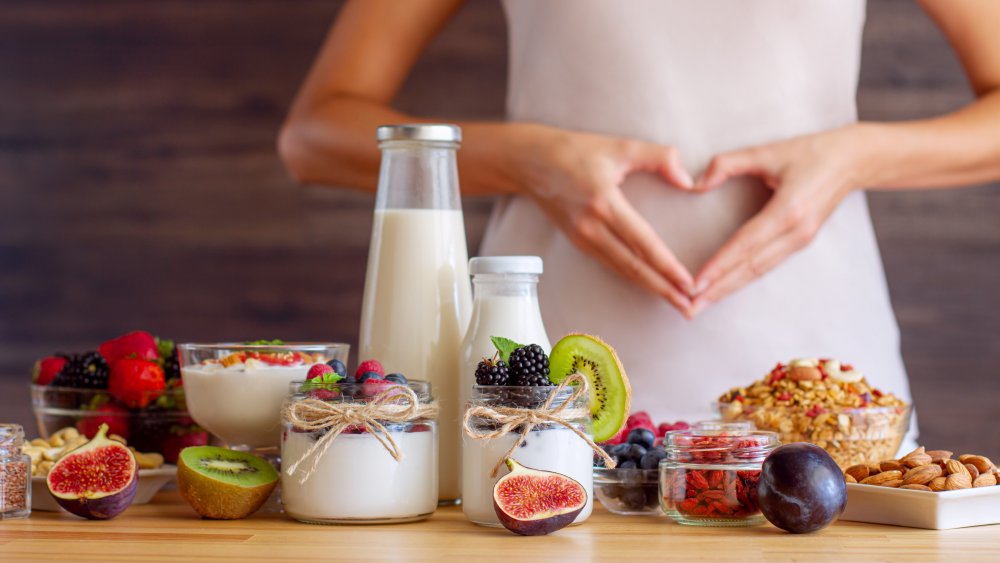 yogurts on table with fresh fruit and nuts