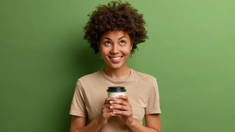 woman drinking hot beverage