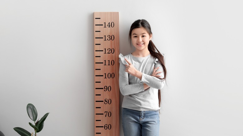 boy angry about being short; girl happy about height, drinking milk