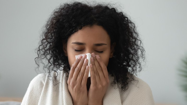 woman blowing nose