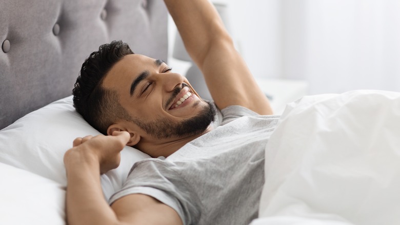 man waking up happy