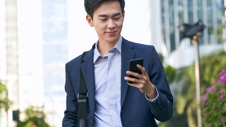 man walking down street on phone