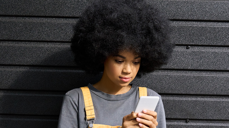 Young woman looking at smartphone