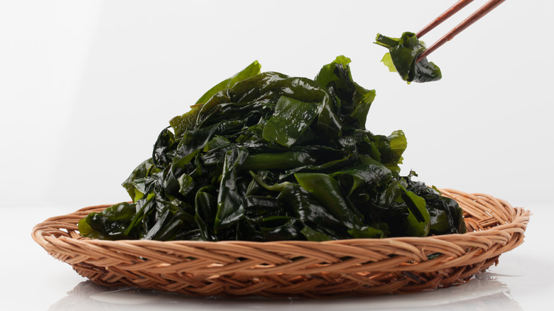 Bowl of seaweed and chopsticks