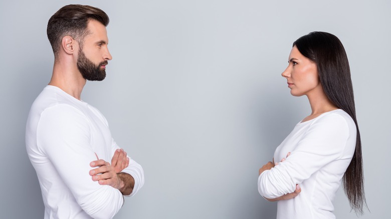 serious man and woman facing each other