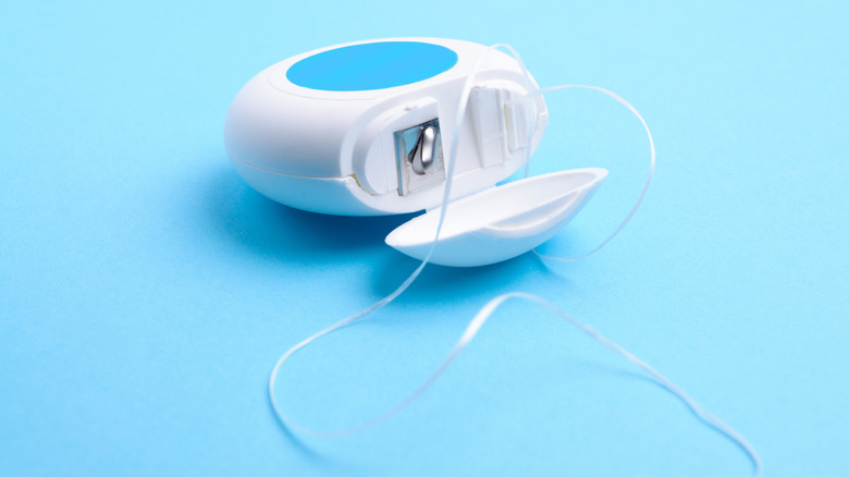 Dental floss on blue background