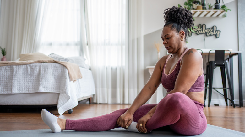 Woman stretching on yoga mat