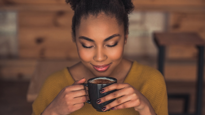 women holding coffee cup