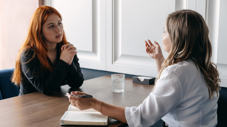 Young female patient is counseled by female doctor